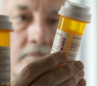 Pharmacist holding prescription bottle