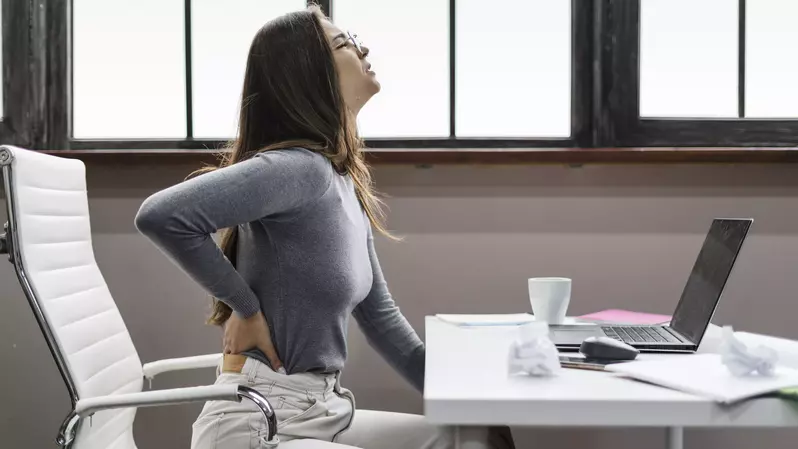 woman hurting her back working