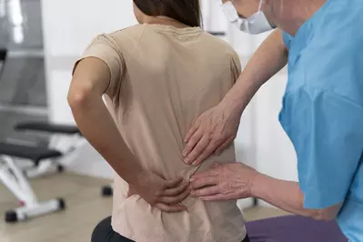 medical assistant helping patient 