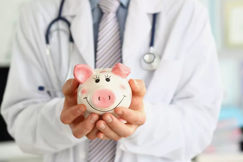 doctor holding a piggy bank