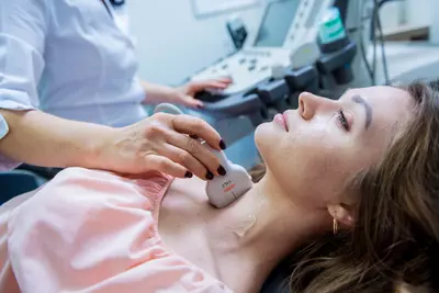 woman getting thyroid checked